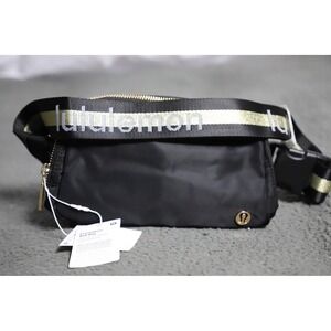 NWT Lululemon Everywhere Belt Bag 1L Black/Gold Wordmark Crossbody Waist Pack